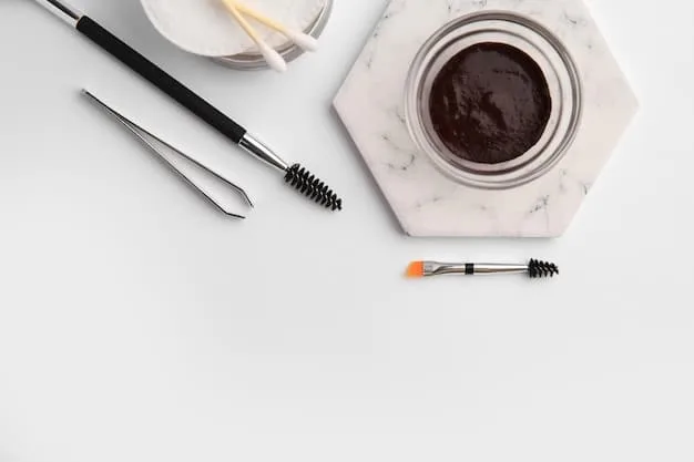 A kit of essential brow shaping tools laid out on a makeup table, featuring tweezers, brow scissors, a spoolie brush, an angled brush, and various brow pencils and powders.