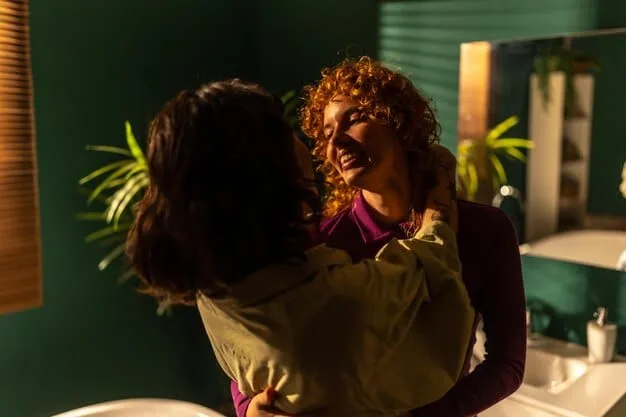 A person hugging themselves in a mirror, smiling confidently at their reflection. The lighting is warm and inviting.