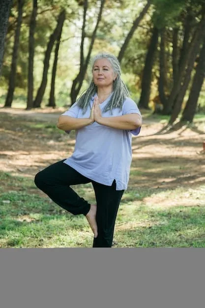 A senior woman practicing yoga outdoors in a peaceful setting. She looks serene and focused, demonstrating the strength and flexibility of her body.