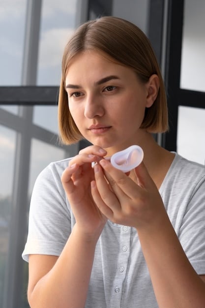 A girl using cotton pad to apply toner on her face after cleansing.