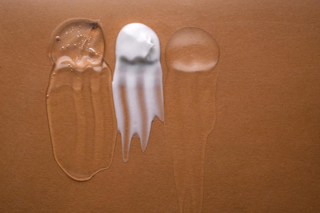 A split image showing two different types of sunscreen: one with a thick, white mineral formula being applied, and the other with a lightweight, clear chemical formula being rubbed into the skin. Labels clearly indicate 