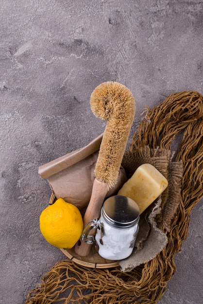 Close-up of different exfoliating tools: a sugar scrub, a konjac sponge, and an electric facial brush. The image showcases the variety of options available for physical exfoliation and highlights their different textures.