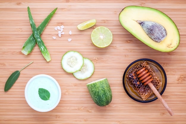 A close-up shot of various natural skincare ingredients, such as sliced cucumber, honey, avocado, and aloe vera, artfully arranged on a wooden surface.