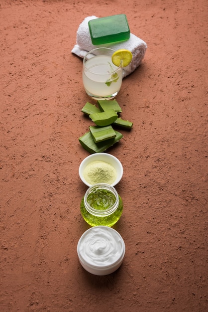 A close-up photo of various natural skincare ingredients, such as aloe vera, shea butter, and green tea leaves, arranged on a wooden surface. Soft, natural light highlights the textures and colors of the ingredients.
