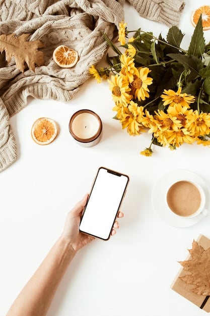 A person placing their smartphone face down on a wooden table in a sunlit room. The room is decorated with calming elements like plants and candles to evoke relaxation.