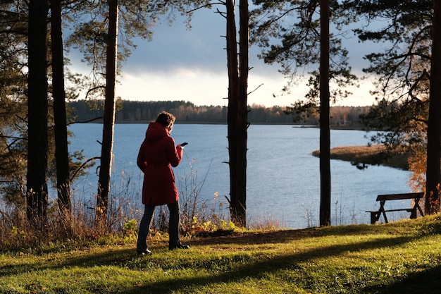 A person enjoying a peaceful nature walk on a Sunday afternoon, surrounded by trees and sunlight, embracing the tranquility of the outdoors.