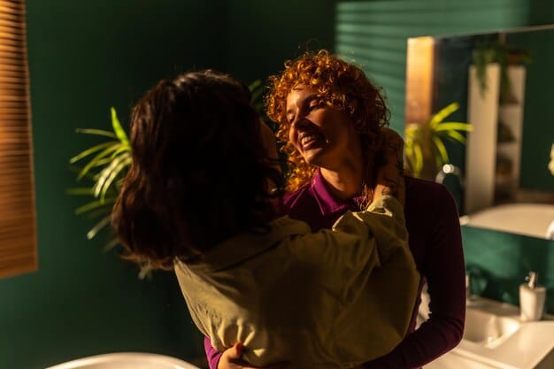 A person hugging themselves in a mirror, smiling confidently at their reflection. The lighting is warm and inviting.