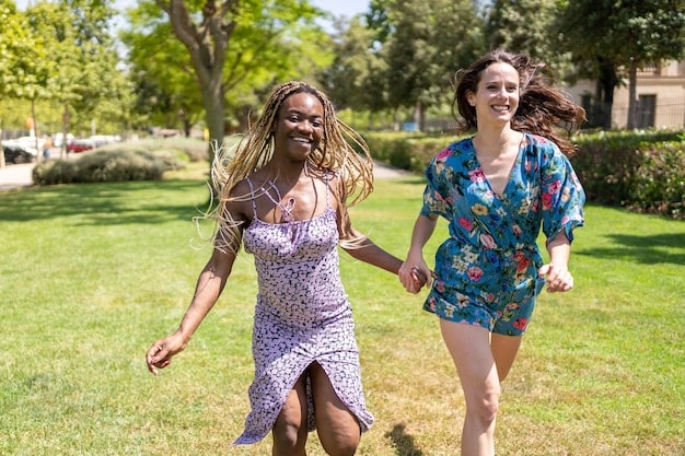 A diverse group of friends walking together in a park, laughing and supporting each other. They are all dressed comfortably and appear to be enjoying each other's company and the natural surroundings.