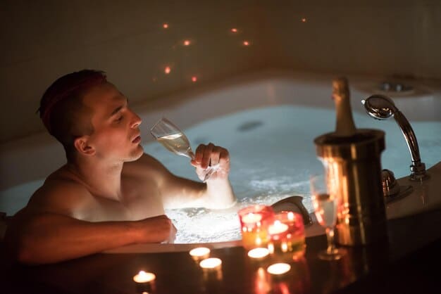 A person relaxing in a bubble bath with candles lit around the tub, showcasing a serene and calming self-care experience.