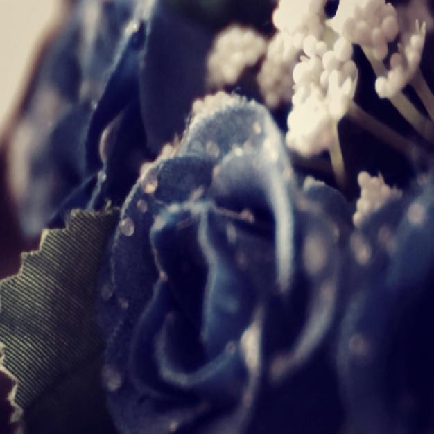 A close-up shot showcasing a variety of fabric textures, including flowing chiffon, structured denim, soft jersey, and stiff taffeta. The image highlights the different ways fabrics can drape and hold shape.