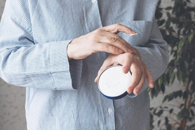 A close-up of a person's hand holding a magnifying glass over the ingredients list on a cosmetic product bottle, emphasizing careful scrutiny.