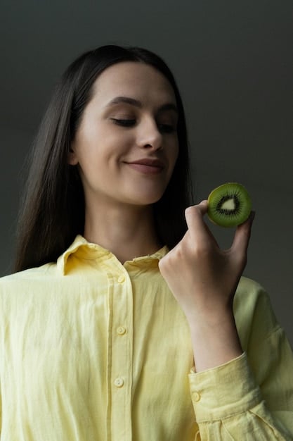 A person holding a single, fresh green apple with balanced, healthy skin, symbolizing a holistic approach to wellness and skin health.