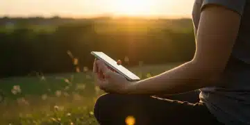 Person meditating outdoors, consciously detaching from digital devices for mental peace.